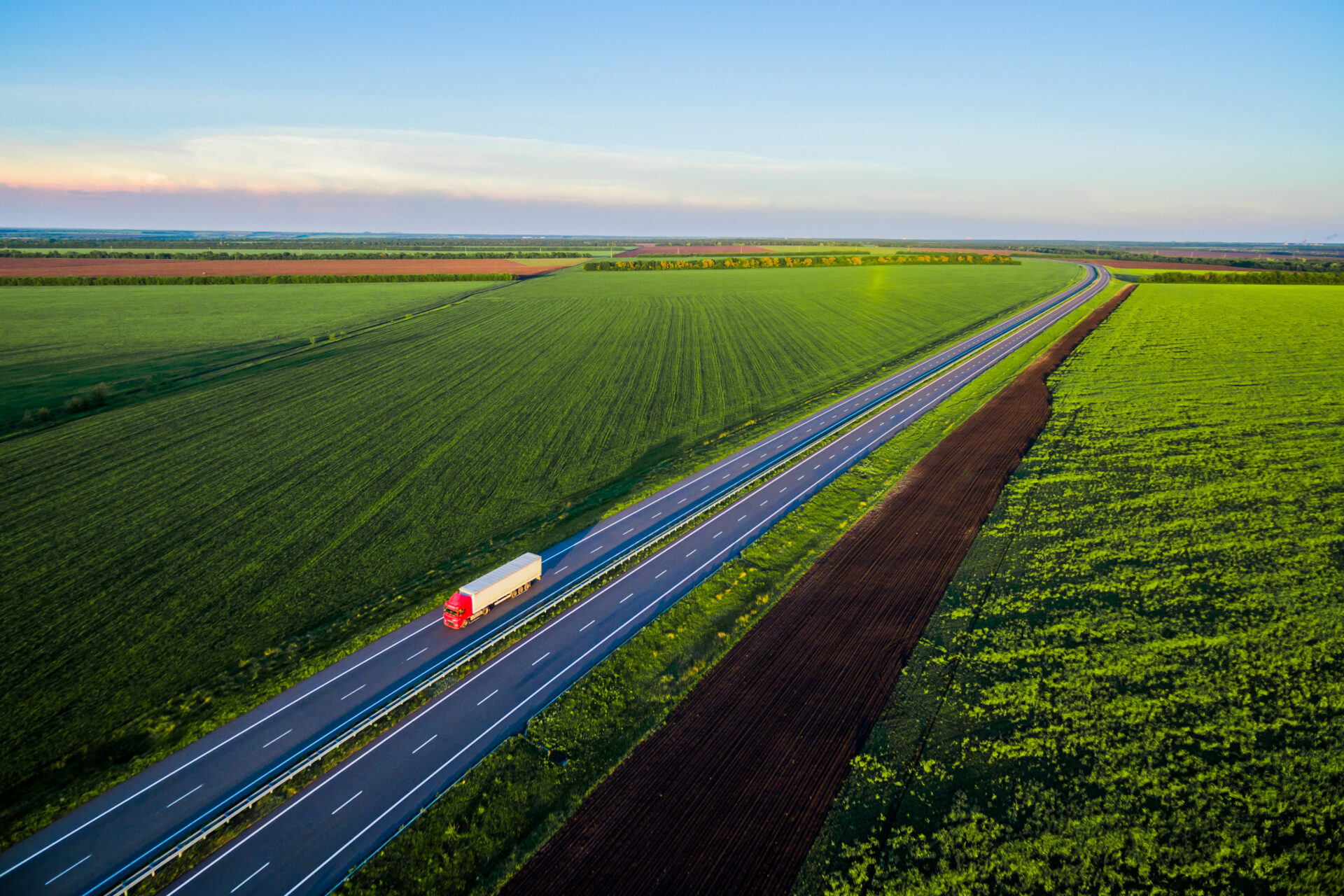 Dump trucks carrying goods on the highway. Red truck driving on